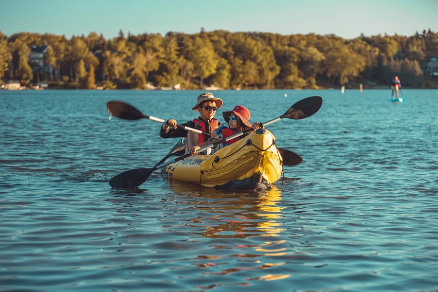 Parent and child kayaking on a lake